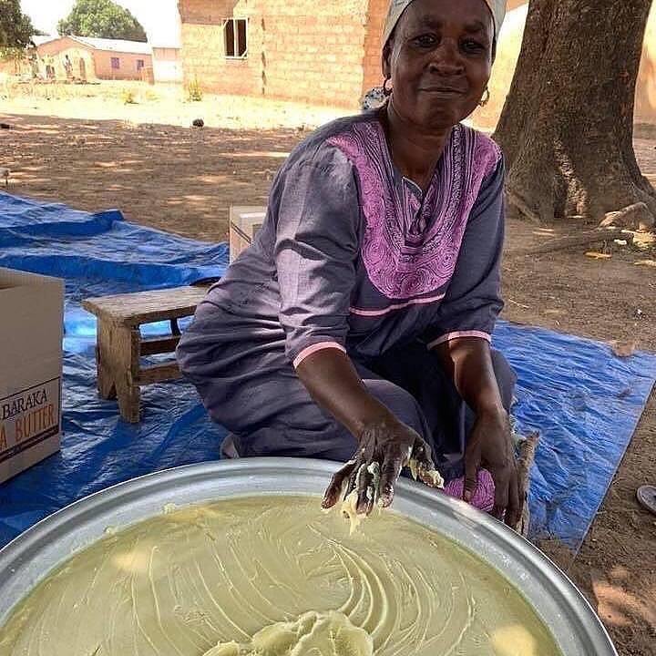 woman
                whipping raw shea butter