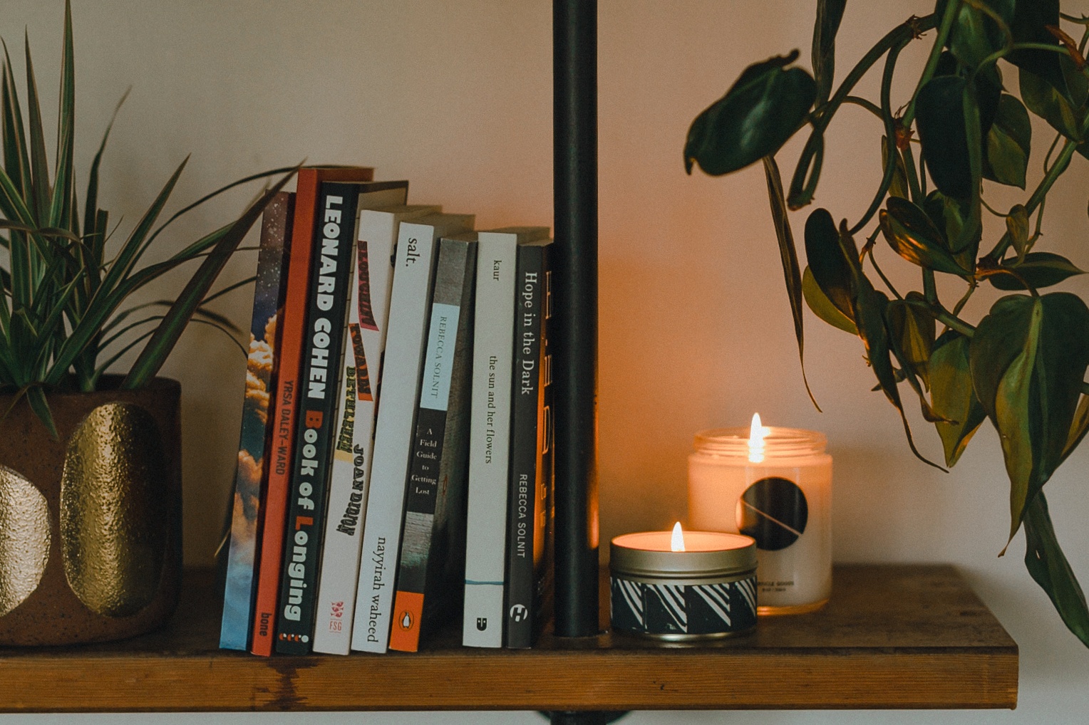 soy wax candles on a bookshelf