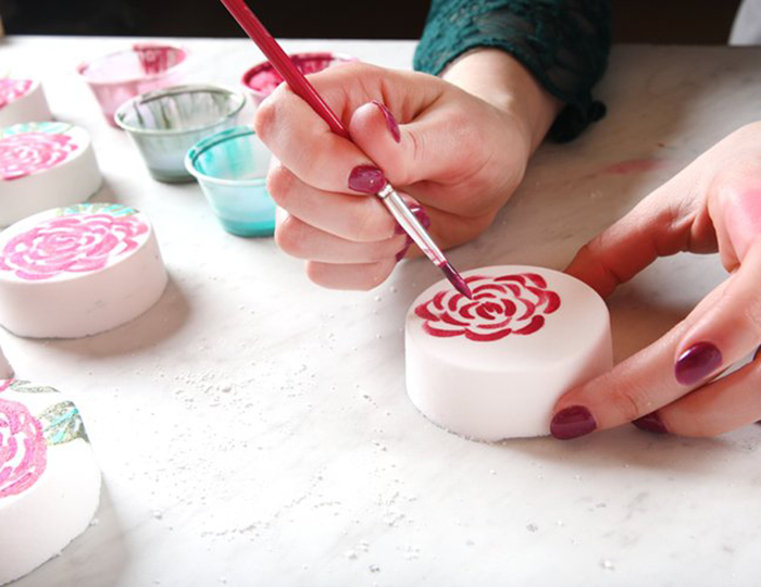 painting rose on bath bomb | bramble
                berry